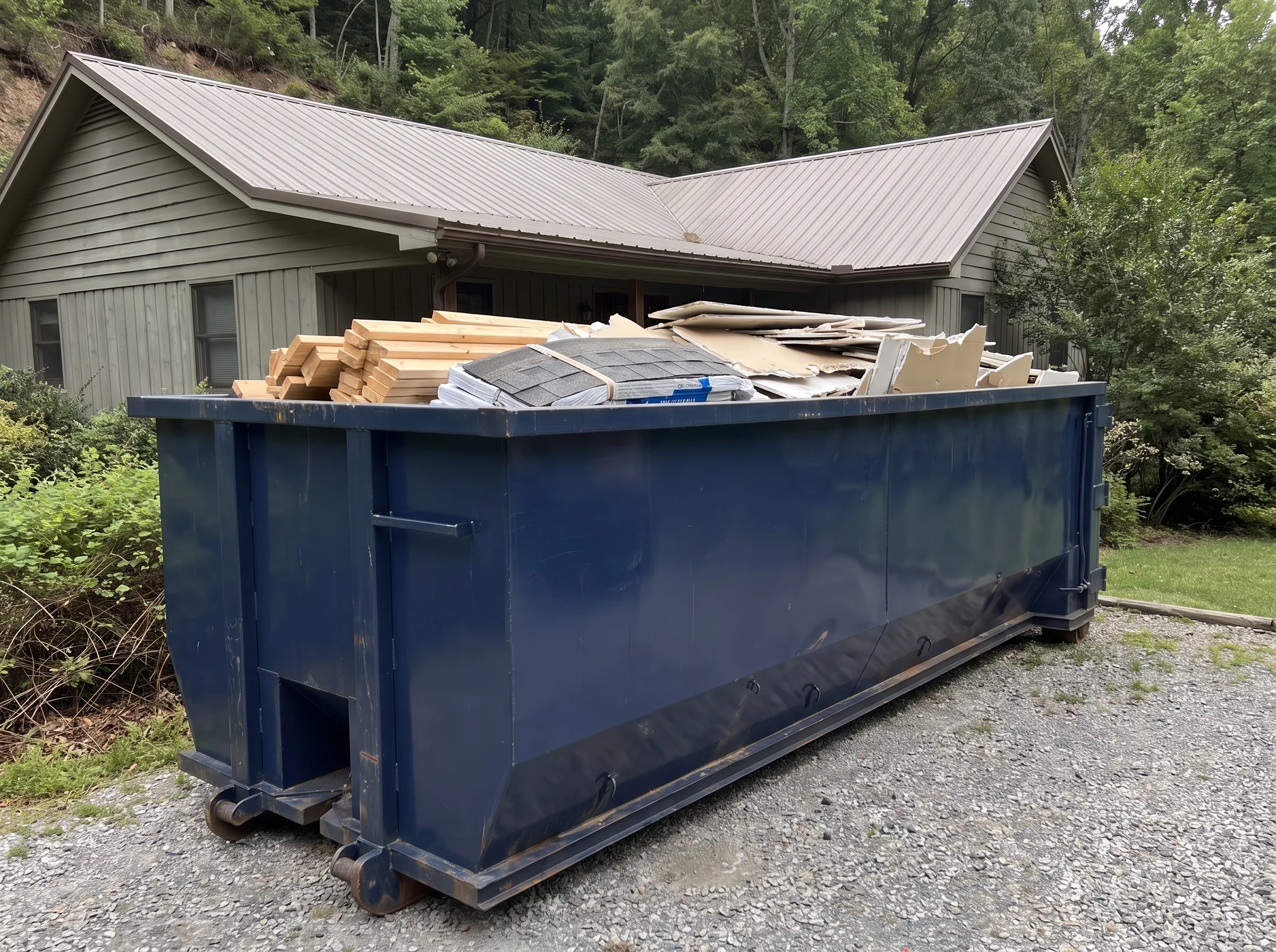 Roll-off dumpster being loaded in Alaska